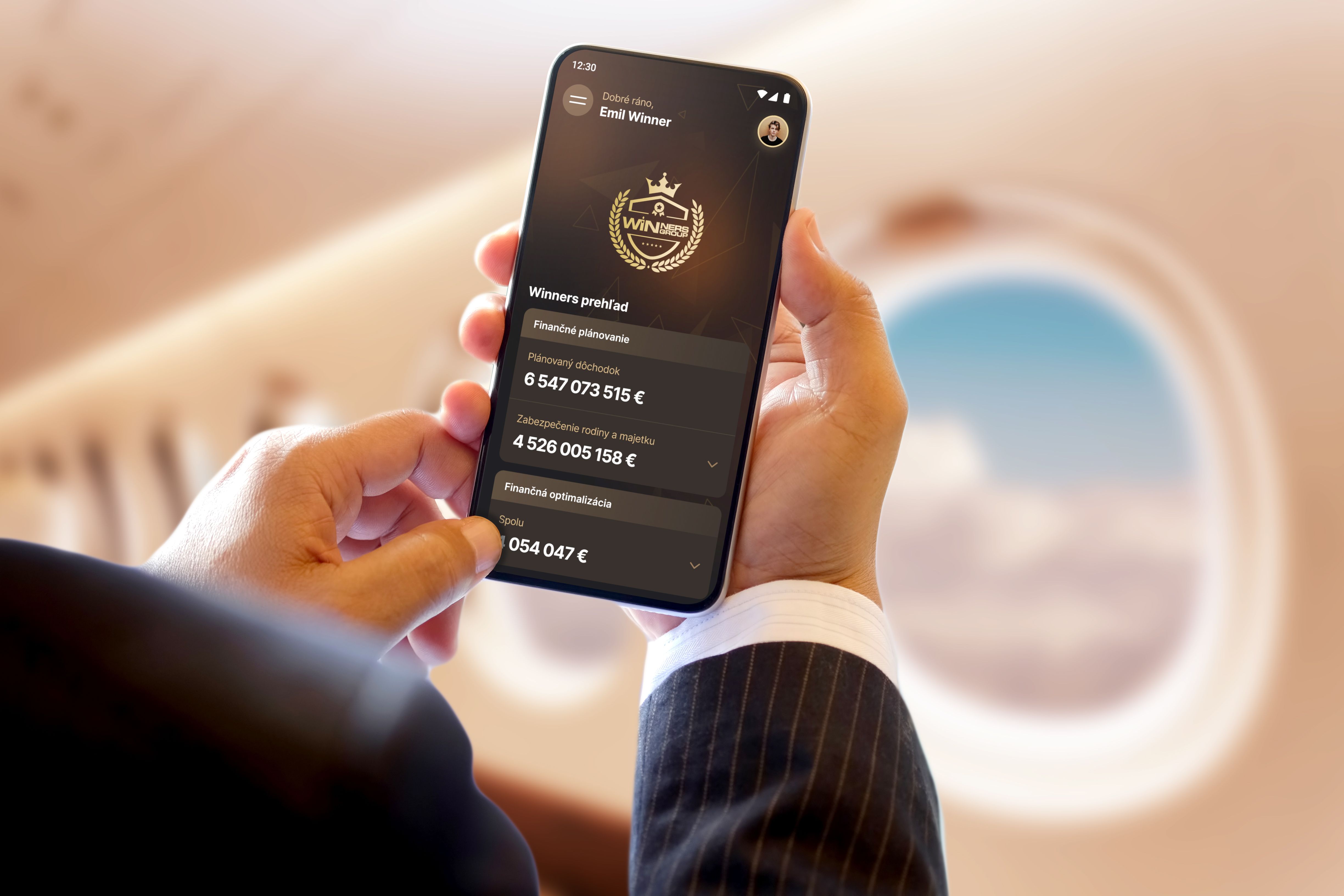 Person holding a phone showing financial planning overview during travel