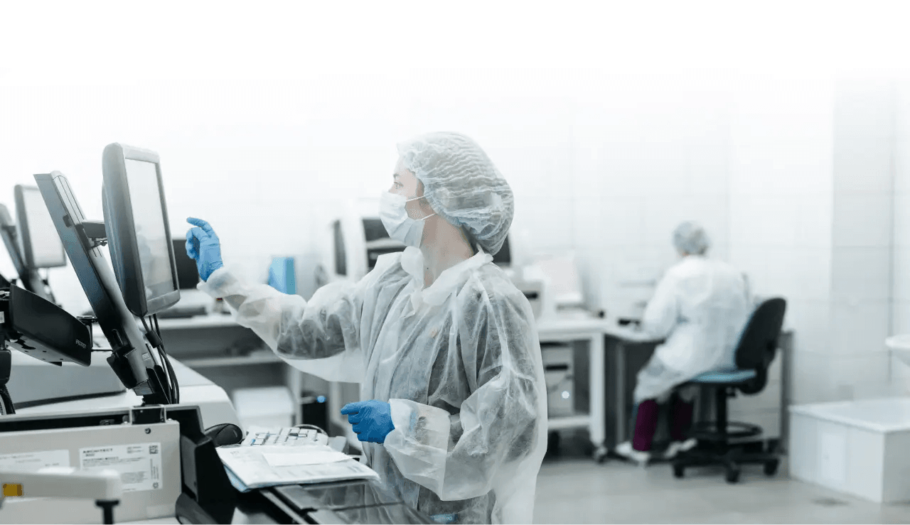Laboratory technician working with equipment in a sterile healthcare environment