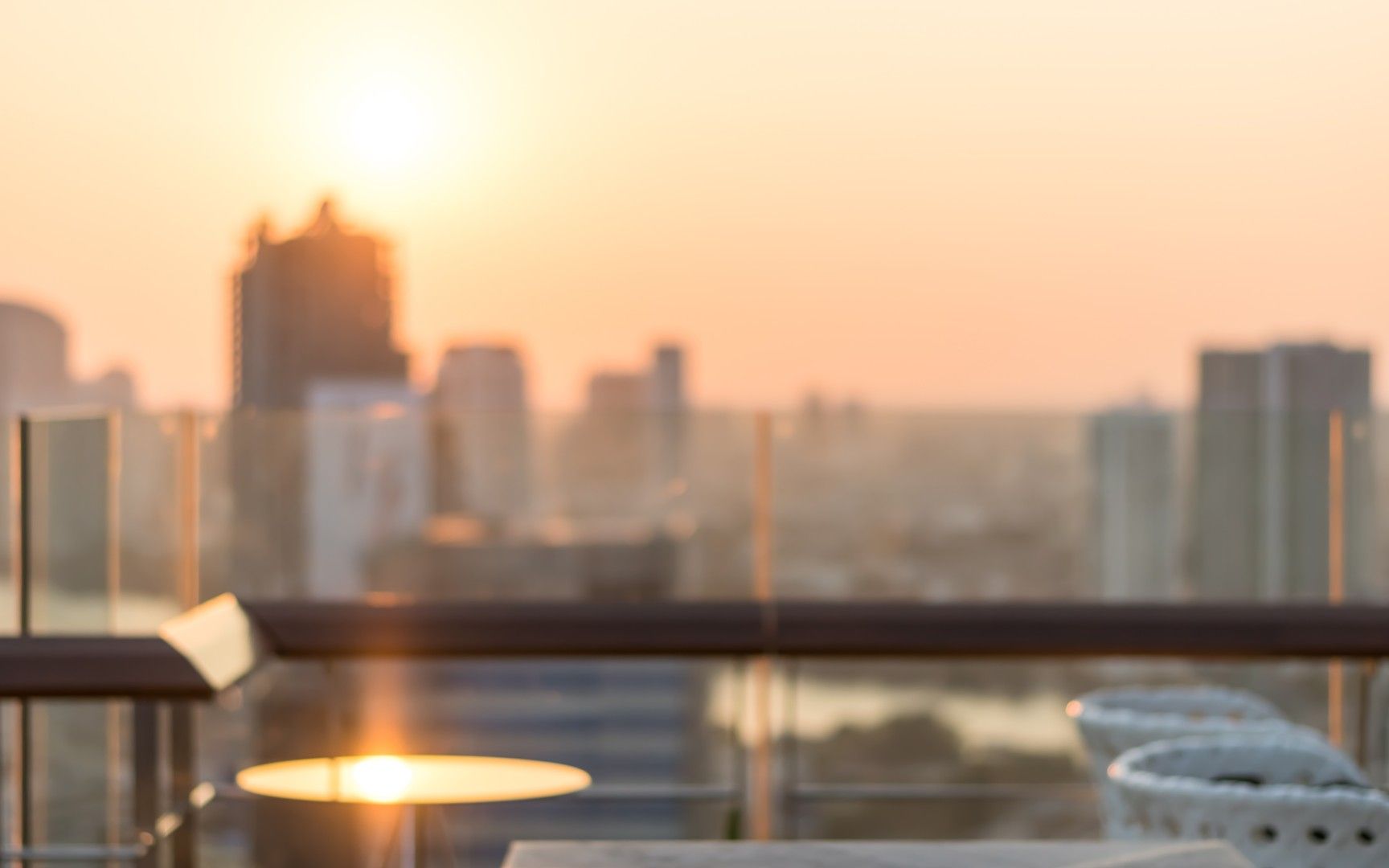 Rooftop terrace at sunset overlooking a city skyline